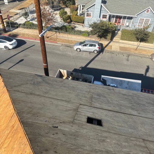 View from rooftop overlooking street and houses.