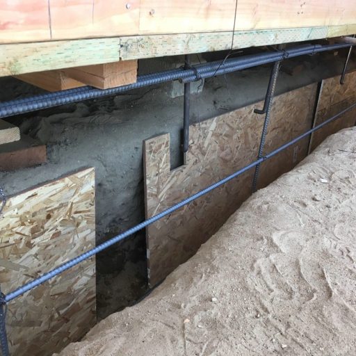 Foundation under construction with wooden supports.