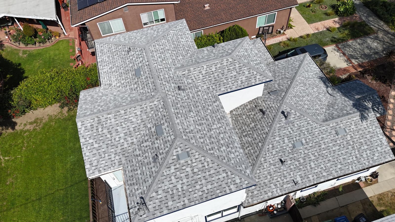 Aerial view of house with gray shingle roof.