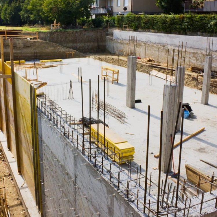 Concrete foundation under construction with wooden beams.