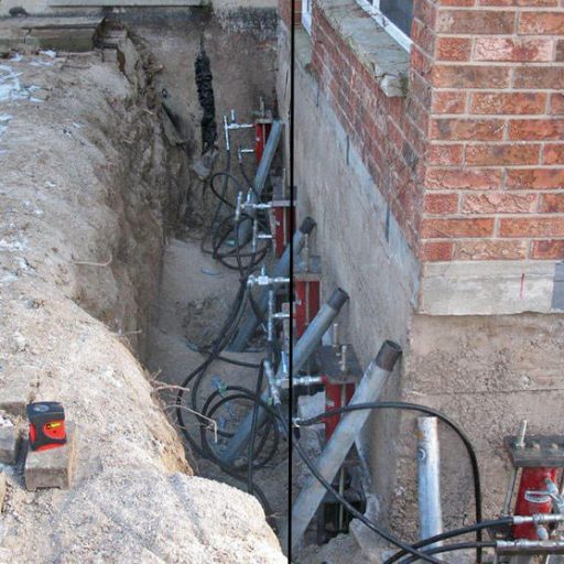 Foundation repair with metal braces and caution tape.